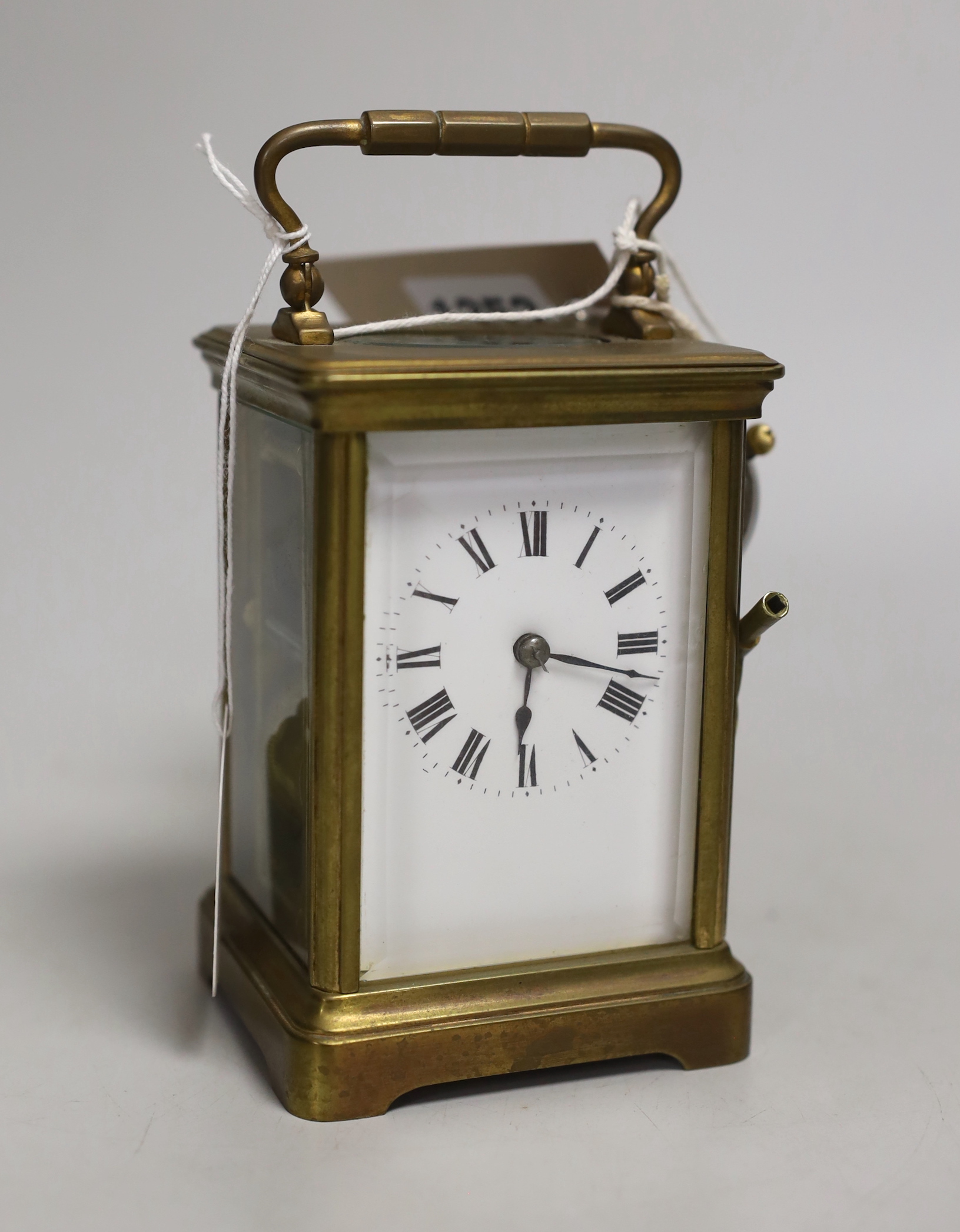 A brass carriage clock and a silver watch, clock 12cm high